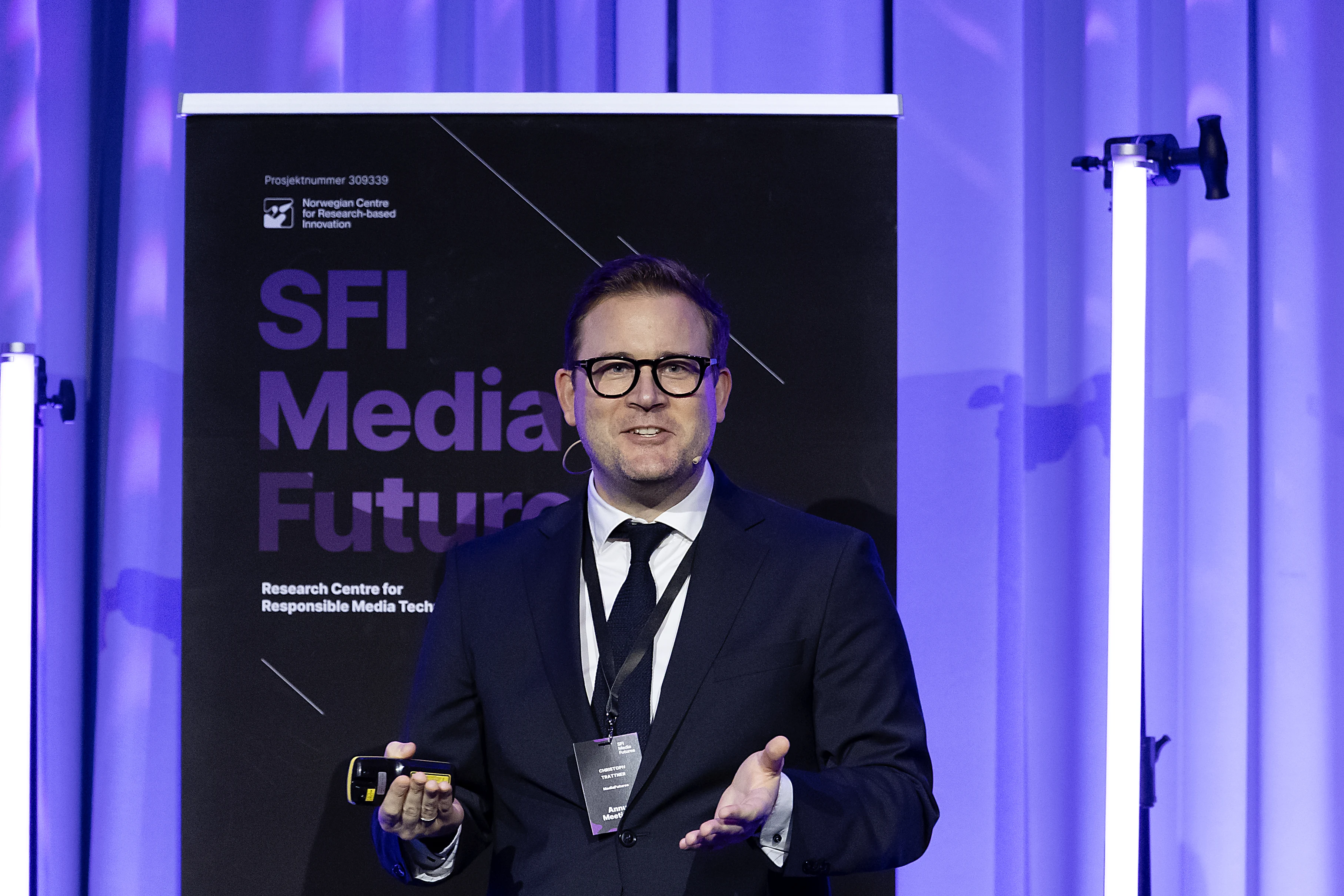 Close-up of Christoph Trattner speaking in front of the SFI MediaFutures banner.